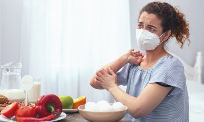 Adolescent lady experiencing allergic itchiness