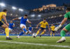 Κηφισιά–Παναιτωλικός 2-0: Δεύτερη σερί νίκη με Πόμπο και Αμπάντα Φάση ποδοσφαιρικού αγώνα με παίκτη σε μπλε φανέλα να σουτάρει απέναντι σε άμυνα με κίτρινες εμφανίσεις